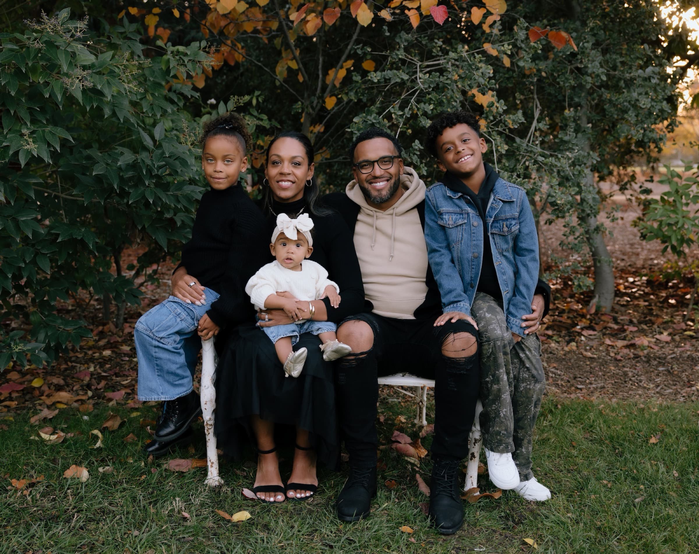 The Sobomehin family on a bench in autumn